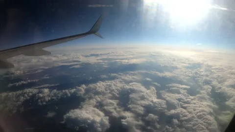 Timelapse of moving clouds through airplane window Stock Footage 135058724