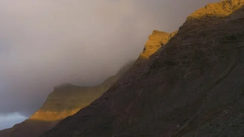 Timelapse moving over mountain ridge with shifting sunlight and clouds 스톡 동영상 331195990