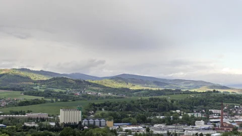 Timelapse of a moving rain cloud over the city transitioning a sunny day to rain Stock Footage 132029413