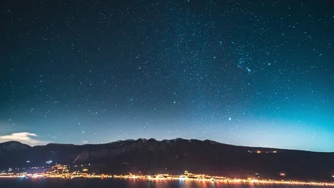 Timelapse of moving star trails in night sky over the mountain Stock Footage