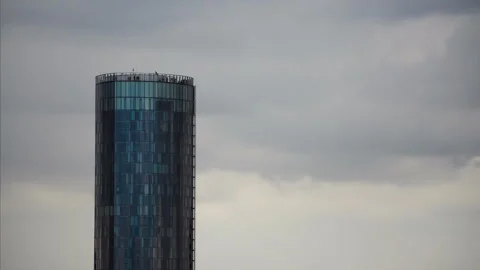 Timelapse of moving thunderstorm clouds with special building and people on top Stock Footage 250081647