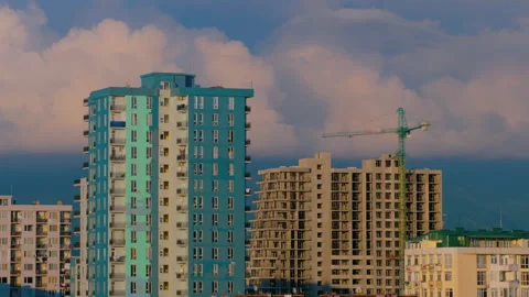 Timelapse: moving turquoise tower crane and unfinished building construction Stock Footage 340429666