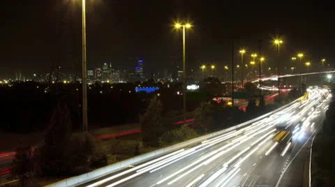 Timelapse at night of busy traffic on freeway with bridge &amp; Melbourne no signs Stock Footage 11226546