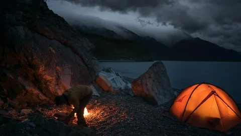 Timelapse of night camping and flame near pond Stock Footage 96489204