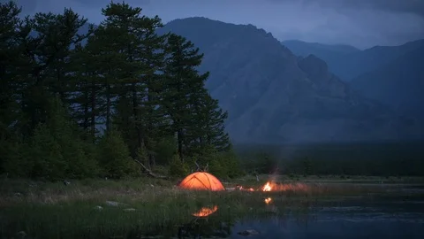 Timelapse of night camping and flame near pond Stock Footage 99322425