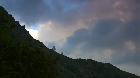 Timelapse night falls on cloudy mountain slope Stock Footage 87846826