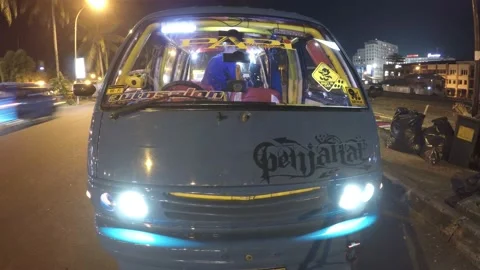Timelapse at night of a parked public transportation in Indonesia Stock Footage 239710372