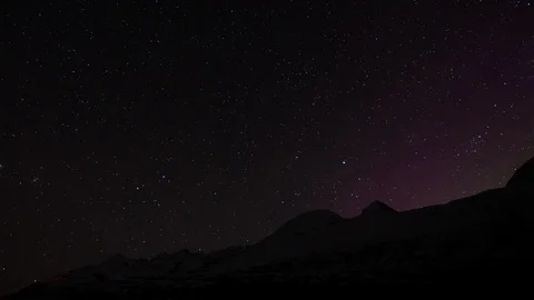 Timelapse of night sky covered in stars shining bright above hills and mountains Stock Footage 124238976