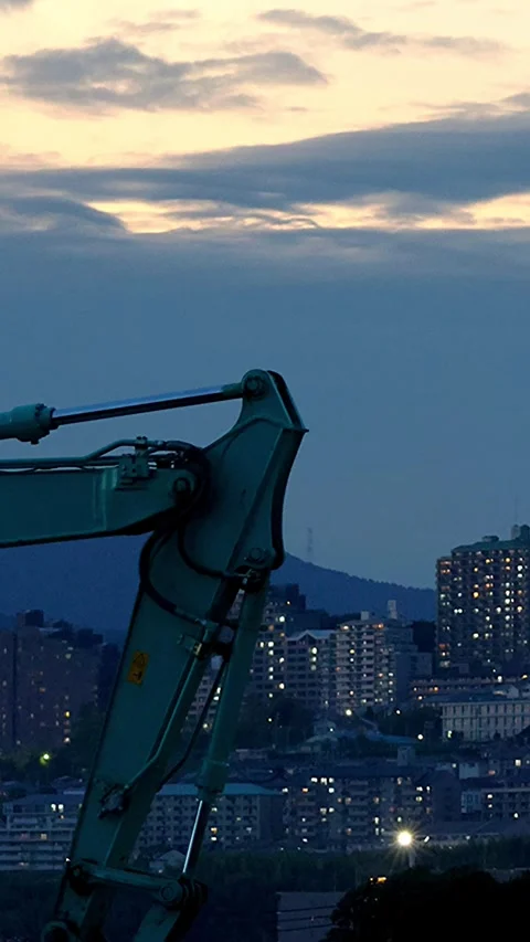 Timelapse night view of an excavator and mountain town lights in Japan,Vertical Stock Footage 346622090