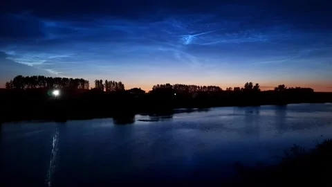 Timelapse of noctilucent clouds in the reflection of the lake 4k Stock Footage 237297285