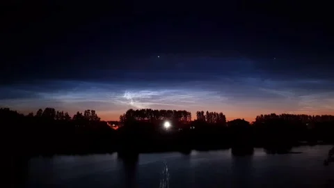 Timelapse of noctilucent clouds in the reflection of the lake 4k Stock Footage 237297338