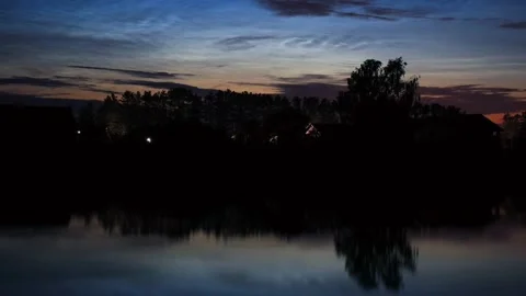 Timelapse of noctilucent clouds in the reflection of the lake 4k Stock Footage 237297570