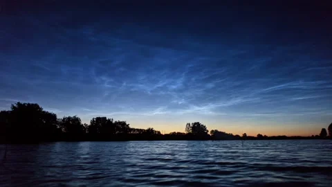 Timelapse of noctilucent clouds in the reflection of the lake 4k Stock Footage 237297572