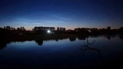 Timelapse of noctilucent clouds in the reflection of the lake 4k Stock Footage 237298353