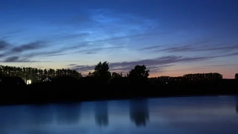 Timelapse of noctilucent clouds in the reflection of the lake 4k Stock Footage 237298374