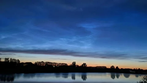 Timelapse of noctilucent clouds in the reflection of the lake 4k Stock Footage 237298386