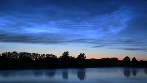 Timelapse of noctilucent clouds in the reflection of the lake 4k Stock Footage 237298413