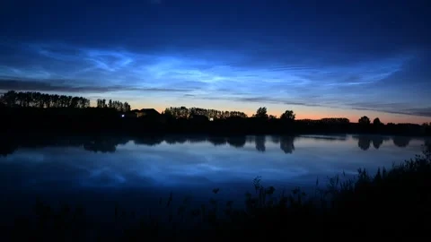 Timelapse of noctilucent clouds in the reflection of the lake 4k Stock Footage 237298476