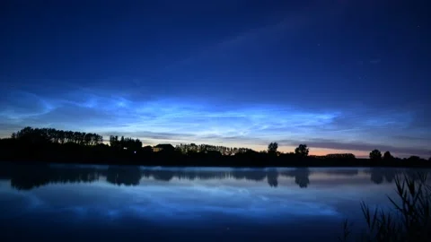 Timelapse of noctilucent clouds in the reflection of the lake 4k Stock Footage 237298484