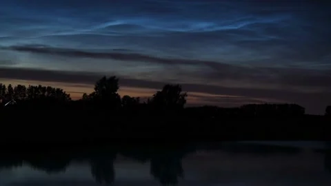 Timelapse of noctilucent clouds in the reflection of the lake 4k Stock Footage 237298500
