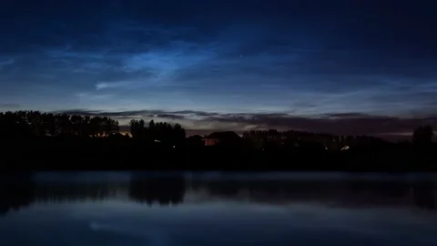 Timelapse of noctilucent clouds in the reflection of the lake 4k Stock Footage 237298524