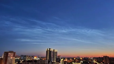 Timelapse of noctilucent clouds in the sky above the city 4k Stock Footage 237297351