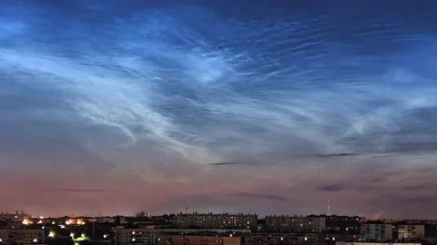 Timelapse of noctilucent clouds in the sky above the city 4k Stock Footage 237297569