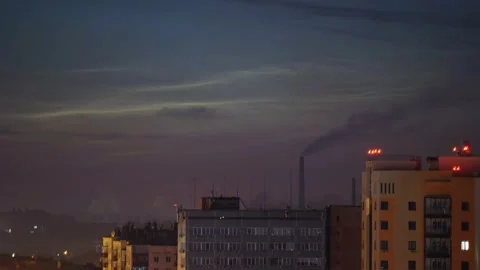 Timelapse of noctilucent clouds in the sky above the city 4k Stock Footage 237297935