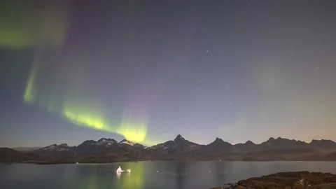Timelapse of Northern Lights dancing over ice fjord of East Greenland Stock-Footage 332380906