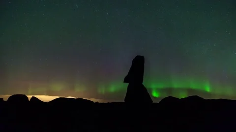 Timelapse of northern lights moving in the starry sky over the rock formation Stock Footage 73010907