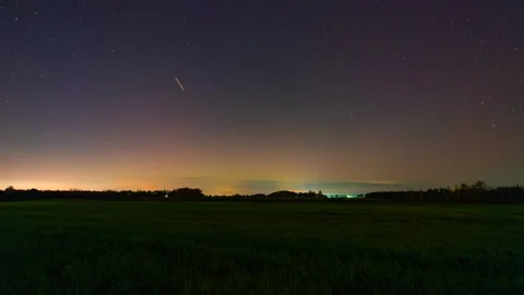 Timelapse of the Northern Lights over fields outside the city Stock Footage 301522037