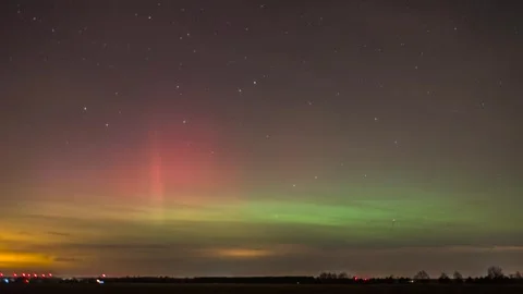 Timelapse of the Northern Lights over fields outside the city Stock Footage 301522921