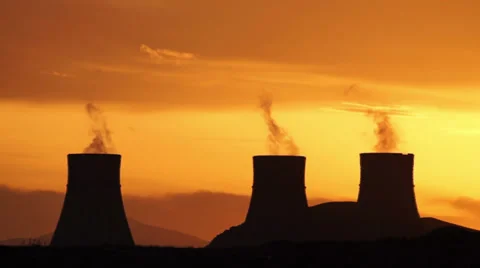 Timelapse of nuclear power plant cooling towers during golden sunset Stock Footage 39342018