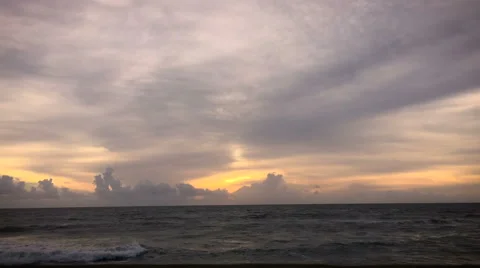 Timelapse of a ocean waves and sunset as the clouds approach Stock Footage 61830321