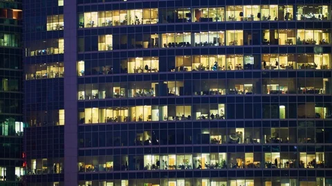 Timelapse of office workers in the windows of skyscraper at evening time Stock Footage 101108261