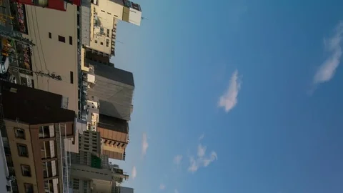 Timelapse of Oncoming Clouds over Omnibus Buildings in Yokohama -Vertical/Pan- Stock Footage