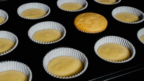 Timelapse - one of many cupcakes, muffins baking and rising in oven: close up Stock Footage 193909016