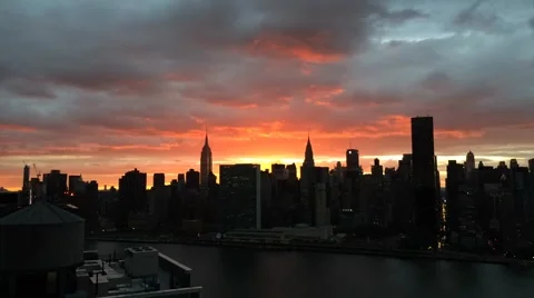 Timelapse- Orange Clouds Moving Across New York City Skyline while ESB and Ch Stock Footage 67357729