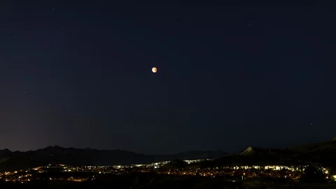 Timelapse Orange Moon During Eclipse with Stars in the Background Stock Footage 89138053