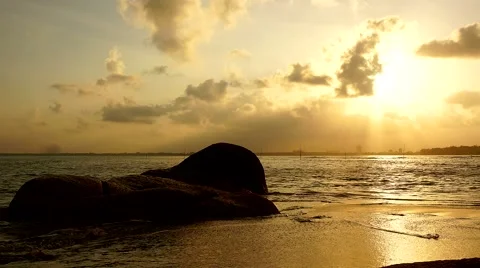 Timelapse of orange sky as sun sets over the sea with fast moving cloud 動画素材 39974946