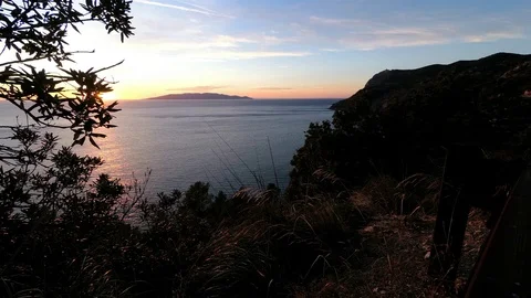 Timelapse Orange Sunset above the sea with the Giglio Island in background Stock Footage 101099277