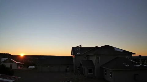 TimeLapse Orange Sunset Mountains behind large house. Stock Footage 957109