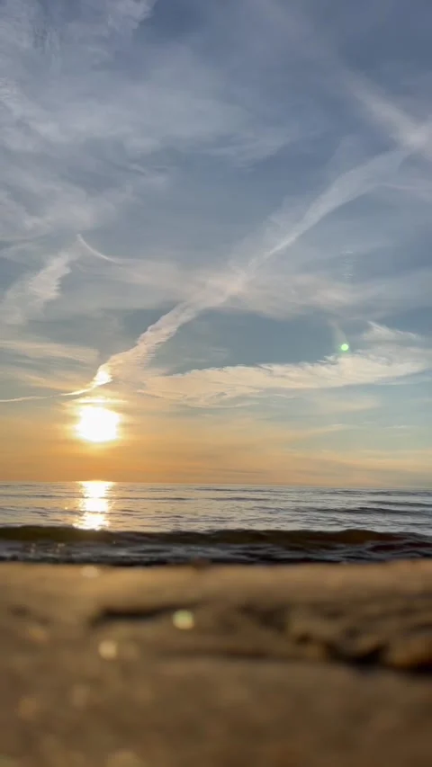Timelapse. Orange sunset sky with clouds, backdrop of ocean waves and the coast. Stock Footage 280237940