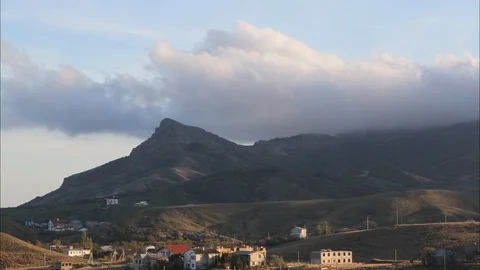 A timelapse over the village in the mountains clouds are flying Stock Footage 99720836
