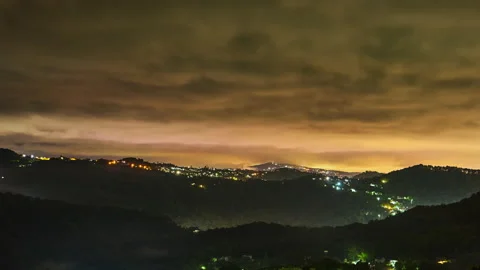 Timelapse of overcast cloudy sky in the last rays of sunset over wooded Stock Footage 223239117