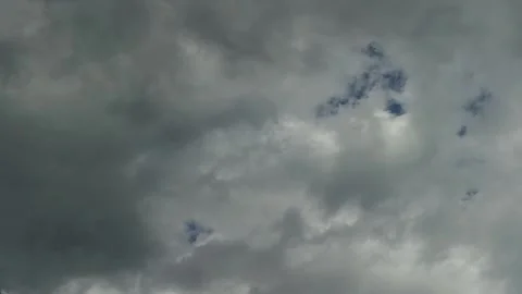 Timelapse of overcast gray storm clouds swirling across a dark blue sky Stock-Footage 344801586