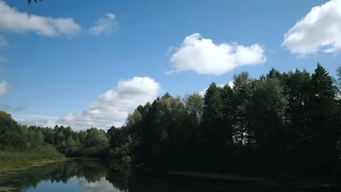 Timelapse overlooking the river, forest and blue sky with fluffy clouds. Stock Footage 166151078