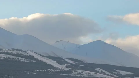 Timelapse of Palandoken Ski Resort as clouds glide over the mountain at sunrise Stock Footage 236945511