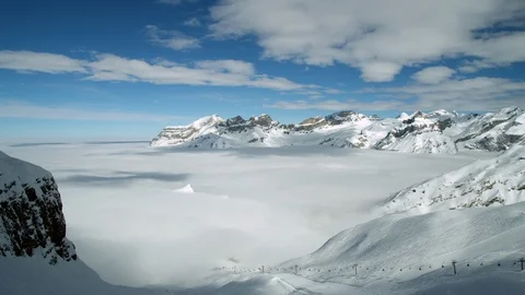 Timelapse panorama of clouds passing over Swiss Alps mountains on sunny day Stock Footage 129098935