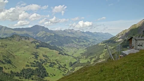 Timelapse panoramic view on Swiss Alpine village. Clouds passes mountains cas Video stock 144448896